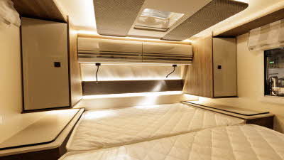 The Roller Team Pegaso 740 has a fixed bed with cupboards either side of it.  There is a skylight above the bed.  It has two overhead lockers and reading lights above each sleeping position