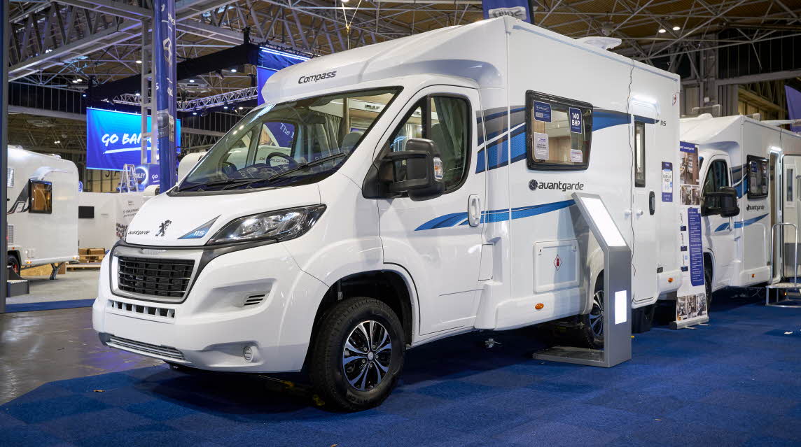 Exterior, coachbuilt motorhome, white with blue/grey accent stripes