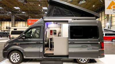 The Bespoke Leisure Bespoke Zermatt Edition is grey, its rising roof and sliding door are open.  There is a step to enable easy access.