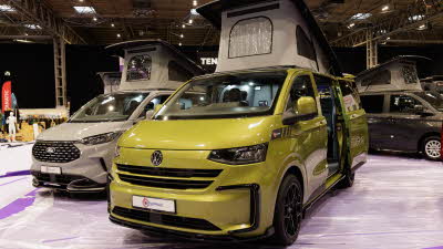 The Bespoke Explore is in Warm Green, its rising roof is fully open and its sliding door is open.