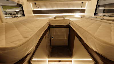 The Roller Team T-Line 750 has a fixed rear bed.  There are locker and reading lights above each bed.  There is a window either side with Roman blinds.