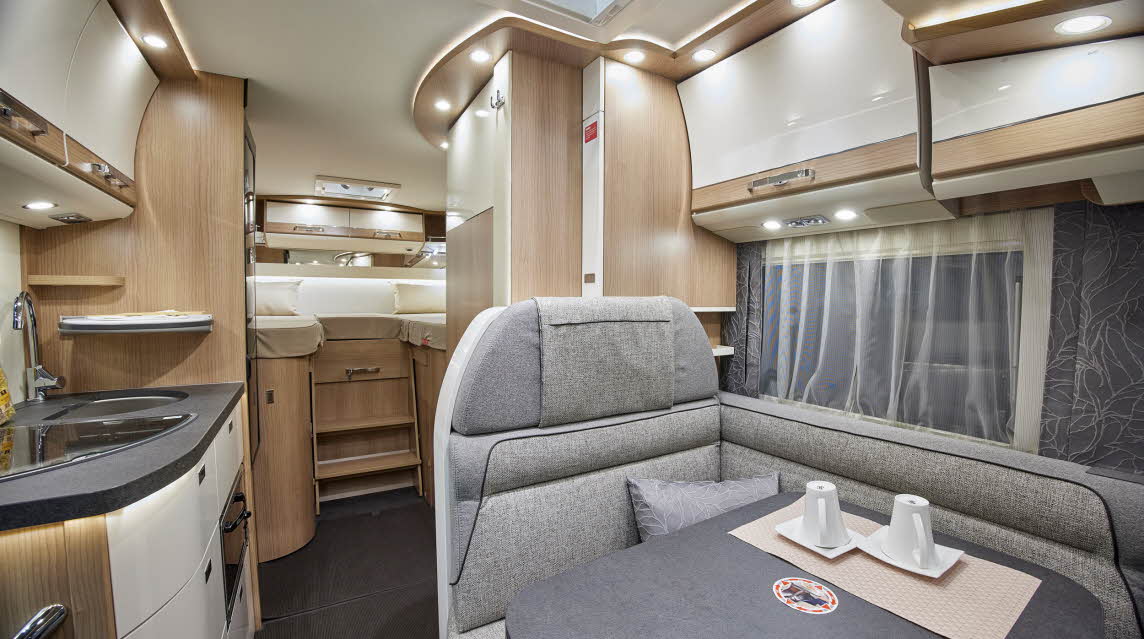 Grey upholstery, wooden furniture, fixed rear bed