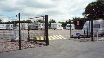 Gated caravan storage facility with green gates