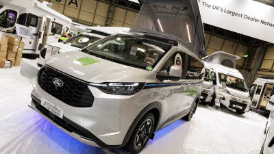 The Panama P\10E is white with blue lights underneath.  There are green decals on it and its rising roof is open.