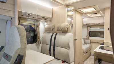 The Elddis Accordo 135 has a beige carpet, with cream and pale brown cabinets.  The upholstery is cream and pale brown.  There are three skylights.  There is a rear lounge.