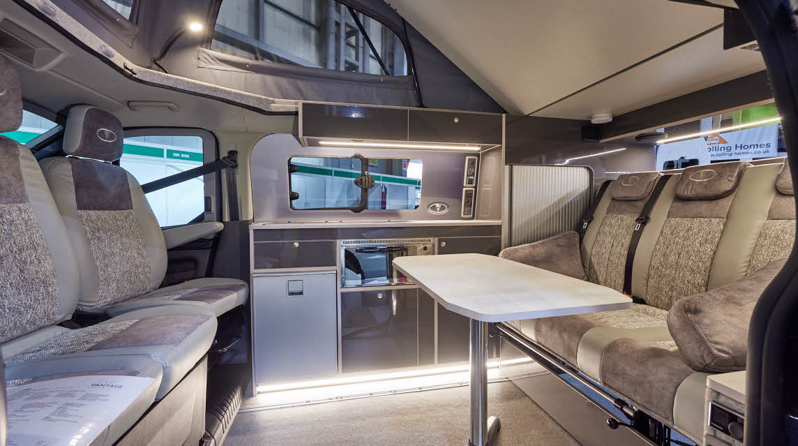 Vantage Luna has three tone beige and brown upholstery, there are six travelling seats.  The floor is beige upholstery.  The rising roof is fully open 
