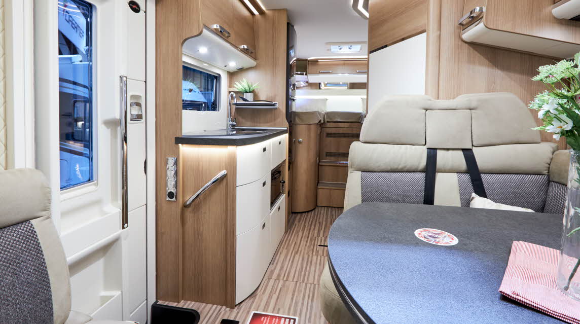 Interior, stripy floor, cream upholstery, wooden cabinets 