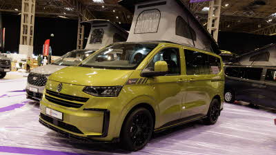 The Bespoke Explore is in Warm Green, its rising roof is fully open and its doors are closed.