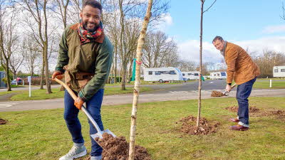 TV presenter and farmer JB Gill and TV presenter Matt Allwright plant silver birch trees at Chapel Lane Caravan and Motorhome Club Campsite