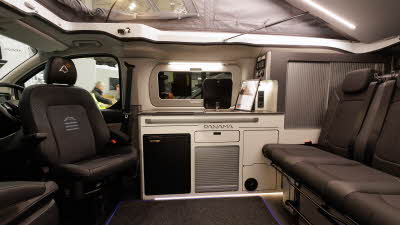 The Panama P\10E has black upholstery and silver tambour doors on the cabinets.  The fridge is black.  Its rising roof is open.
