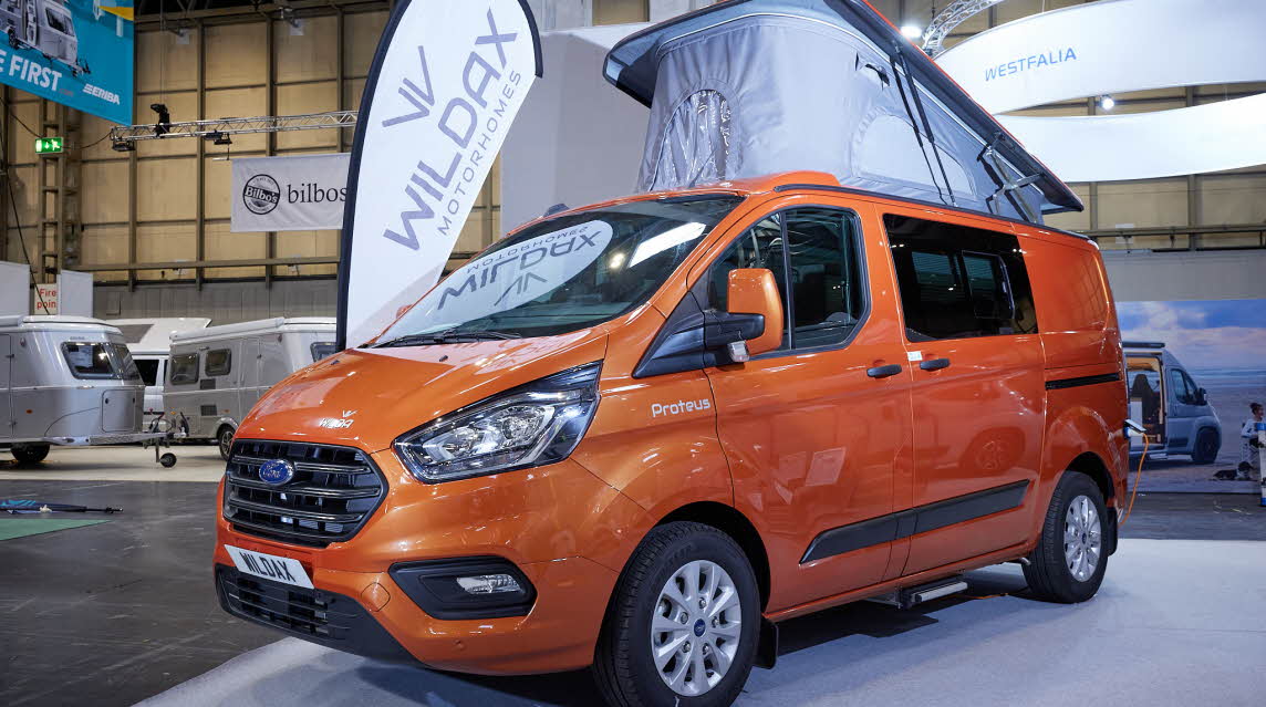 WildAx Proteus has an orange cab exterior. The rising roof is fully risen and has a pale grey canvas