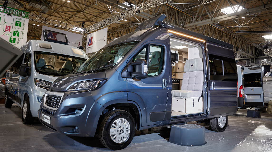 Auto-Sleeper Symbol exterior, the motorhome is blue, the sliding door is open showing into the interior, with a step to gain easy access.  The roof light is fully open.