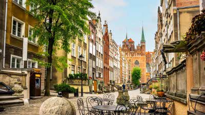 cafe tables on the street in Gdansk with typical local architecture