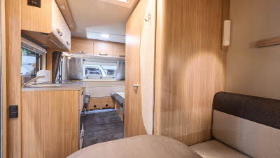 Weinsberg CaraOne 400 LK Dinette's interior is primarily wooded, the dinette is situated in the front with two tone brown seating.  The two single beds are situated at the rear.