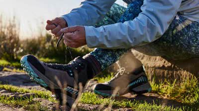 Person tying up their hiking boots