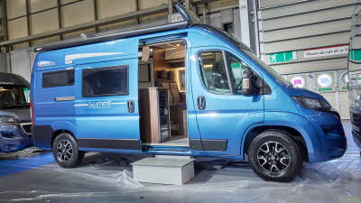 Globecar Summit Prime 600, the vehicle has a blue exterior and its sliding door is open showing into the interior, with a step to gain easy access.  