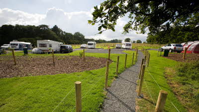 Pathway through cut grass and campsite