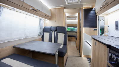 Coachbuilt interior, grey and cream upholstery, wood and cream furniture