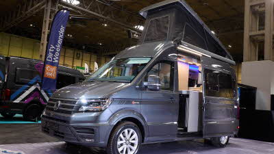 The Bespoke Campers Edition (Four Berth) is grey.  The habitation sliding door is open which reveals the interior.  The pop top roof is fully open.