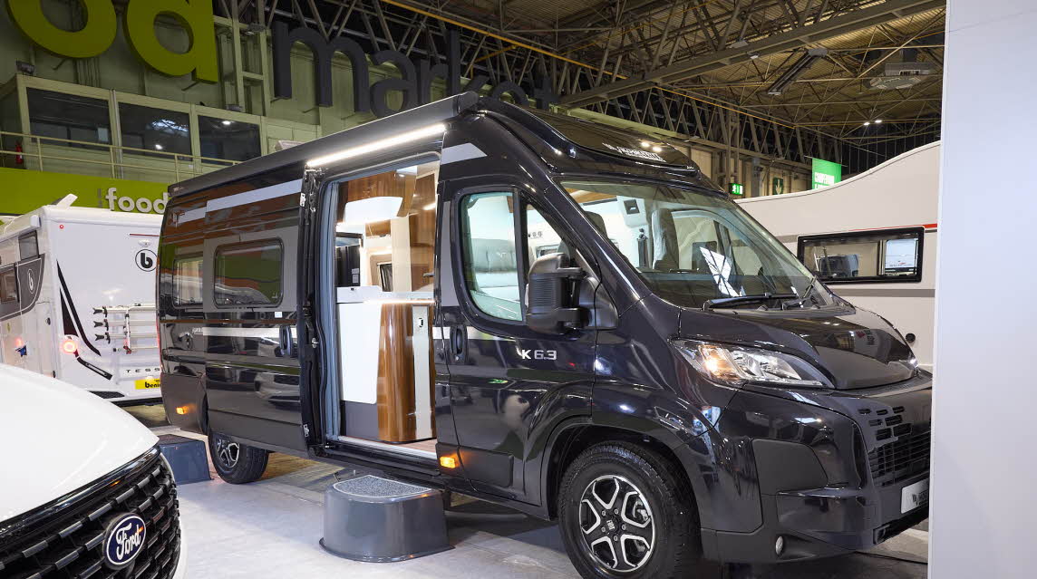 The Mobilvetta Admiral K6.3 is black with gold decals.  There is a black step by the open sliding habitation door which reveals the interior.