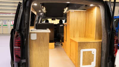 Rolling Homes Camper Ltd Livingstone's furniture is made from solid wood and its kitchen is to the rear.