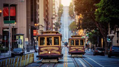 traditional Cable Cars riding on famous California Street