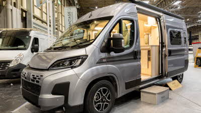 The Vantage TEO is silver, its sliding door is open.  There is a step to gain easy access.