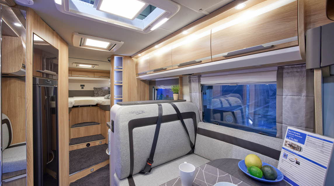 Wooden furniture, grey upholstery, fixed rear bed