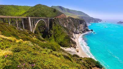 Bixby bridge stretching across along the left with the stunning turquoise ocean to the right 