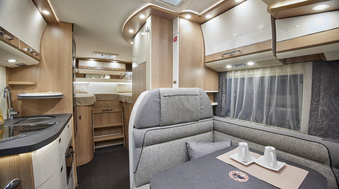 Grey upholstery, wooden furniture, fixed rear bed