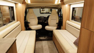 The Auto-Trail Imala 615 has cream upholstery.  The two front seats are swivelled to face into the motorhome.  There is beige removable carpet on the floor.