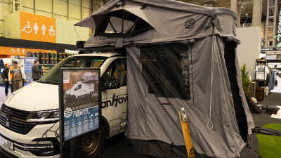 The Latitude Tents Pioneer XL has grey canvas with two windows.  Its door is open, it is shown on a white vehicle.