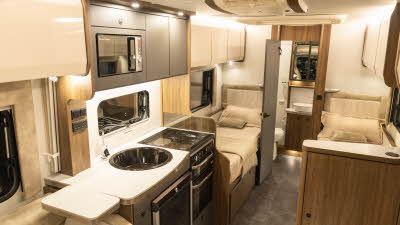 The Buccaneer Quantum F-4S has twin fixed single beds.  The kitchen is front left.  At the rear the open door reveals the end washroom.