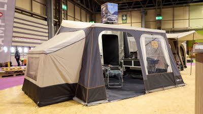The Camp-Let North has a cream canvas roof with a grey canvas for the main body of the tent. The doors are open revealing the interior.