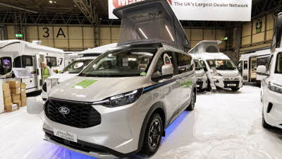 The Panama P\10E is white with blue lights underneath.  There are green decals on it and its rising roof is open.