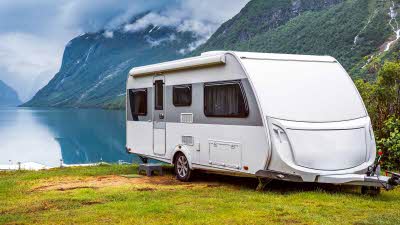 caravan pitched beside a Norwegian lake