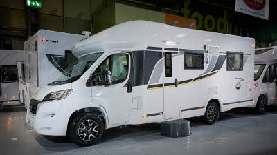 Benimar Primero 282’s exterior is a white with black, grey and yellow decals.  The entrance door is closed and there is a step to gain easy access.  