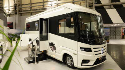 The MORELO HOME 78L has a black and white exterior.  Its habitation door is open and there are three steps to gain easy access.  The rear garage locker is open