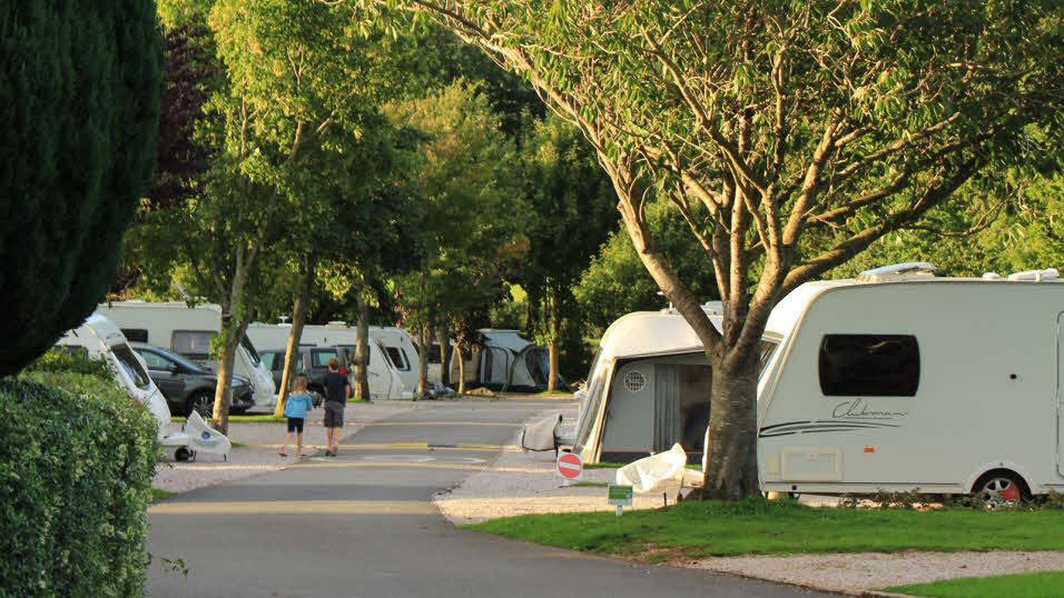Ramslade club site caravan and motorhome pitches with children walking on site
