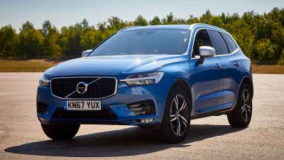 Blue Volvo parked on a racing track