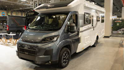 The Elddis Autoquest APEX 196+ has a grey cab and a white coachbuilt body.  It has grey striped decals along the sides.