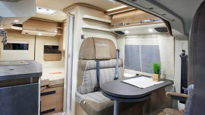 Van conversion, grey table, beige/patterned exterior