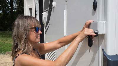Woman locking a motorhome from the outside