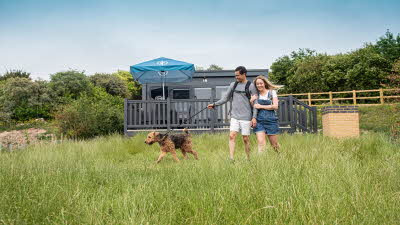 Couple with dog glamping pod