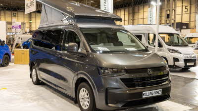 The Rolling Homes Camper Ltd Livingstone is dark grey and has its rising roof open.