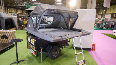 The Roof Space 2 is fully extended on a trailer.  The canvas is pale grey.  There is a platform with a sturdy ladder to gain easy access.