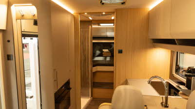 The MORELO HOME 78L has a rear fixed bedroom.  Its kitchen is to the right.  There are cream cabinets throughout.