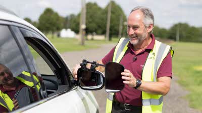 Training course instructor adjusting mirrors