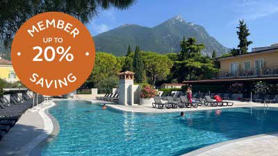 swimming pool, deck chairs, people, mountain, trees