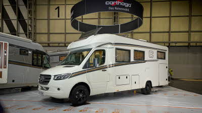 Carthago c-tourer T 148 LE H’s exterior is white with dark and gold decals.  